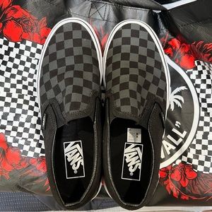 Black Checkerboard slip on. Size 7 in women’s, mens/boys 5.5.